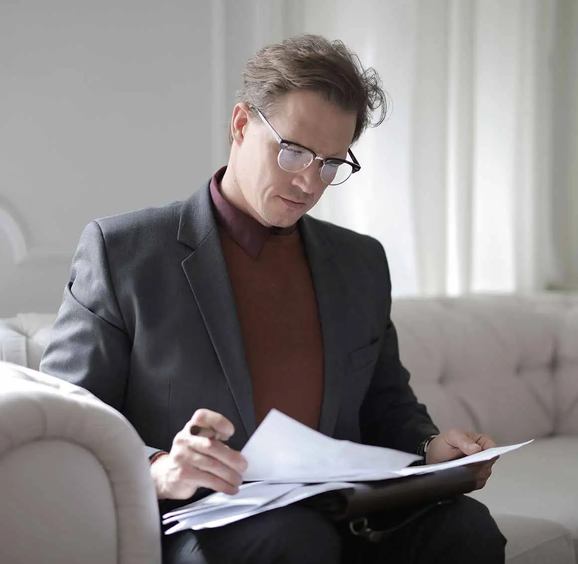 Professional notary public reviewing and authenticating legal documents for official validation.